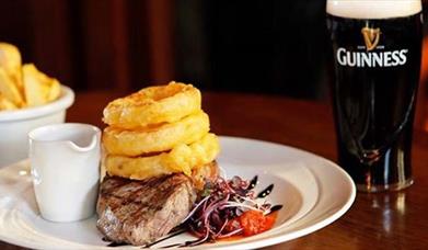 Guinness, steak, onion rings, and chips in smugglers inn waterville