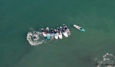 surfers in brandon bay